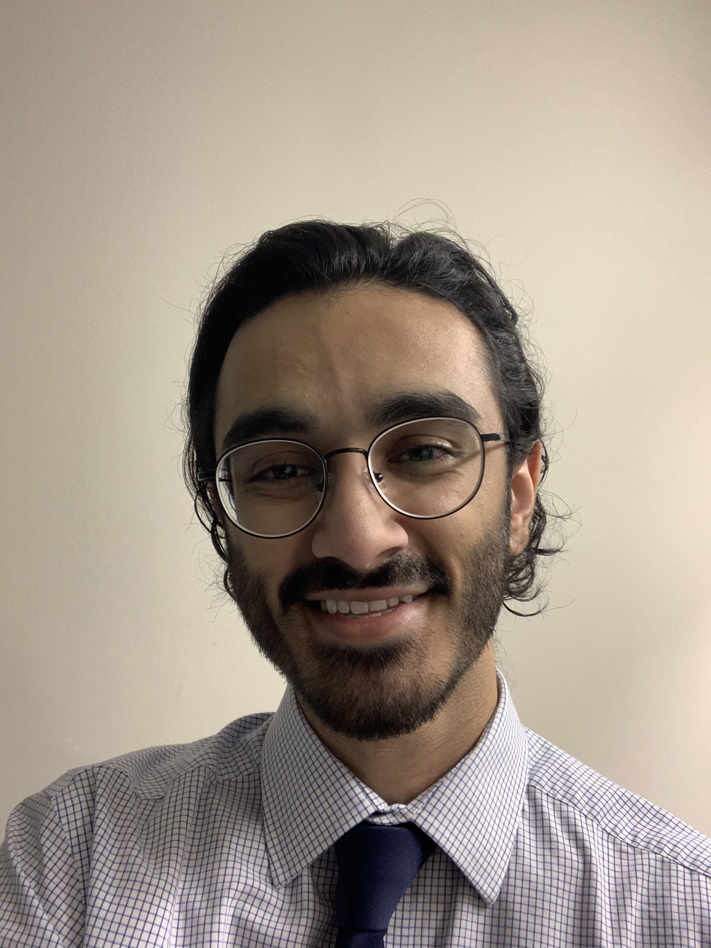Zeshan Ahmad smiling in a dress shirt